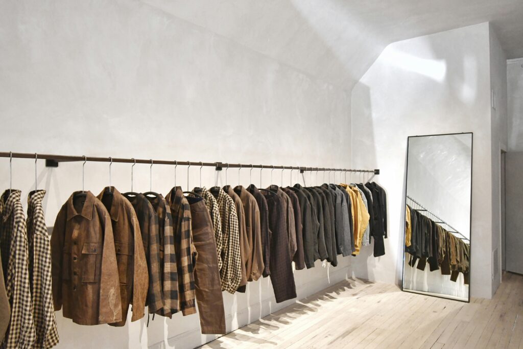 A store featuring a rack of shirts and coats