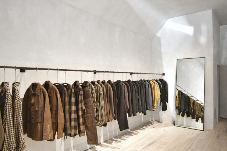 A store featuring a rack of shirts and coats