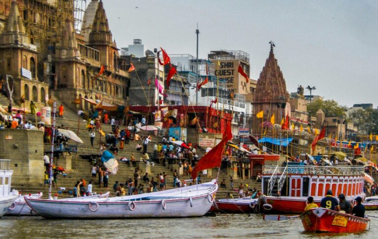 Boats and people along the ghats of Varanasi, India, symbolizing cultural heritage and economic vibrancy along the Ganges River